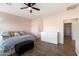 Guest bedroom with wood-look floors, large windows and an ensuite bathroom at 19146 W Pasadena Ave, Litchfield Park, AZ 85340