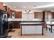 Modern kitchen with dark wood cabinets and granite countertops at 19146 W Pasadena Ave, Litchfield Park, AZ 85340