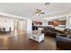 Open concept living area with hardwood floors, and a view into the kitchen and dining area at 19146 W Pasadena Ave, Litchfield Park, AZ 85340