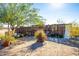 Landscaped backyard with plants, gravel, and a wooden fence at 19350 W Clarendon Ave, Litchfield Park, AZ 85340