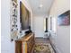 Bright entryway with decorative wall art and a wooden console table at 19350 W Clarendon Ave, Litchfield Park, AZ 85340