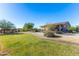 Single story home with grassy lawn and desert landscaping at 19350 W Clarendon Ave, Litchfield Park, AZ 85340