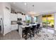 Modern kitchen with island, stainless steel appliances, and access to a patio at 19350 W Clarendon Ave, Litchfield Park, AZ 85340