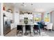 Modern kitchen featuring white cabinetry, an island, and a dining area at 19350 W Clarendon Ave, Litchfield Park, AZ 85340