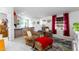 Cozy living room features comfortable armchairs and a red accent ottoman at 19350 W Clarendon Ave, Litchfield Park, AZ 85340