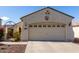 Single-story home with a two-car garage and well-manicured landscaping at 20518 N 261St Ave, Buckeye, AZ 85396