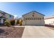 House exterior showcasing a two-car garage and desert landscaping at 20518 N 261St Ave, Buckeye, AZ 85396