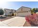 Two-story home with a two-car garage and colorful landscaping at 20518 N 261St Ave, Buckeye, AZ 85396