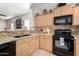 Kitchen features granite countertops and black appliances at 20518 N 261St Ave, Buckeye, AZ 85396