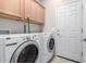 Laundry room with washer, dryer, and cabinets at 20518 N 261St Ave, Buckeye, AZ 85396