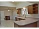 Open kitchen with breakfast bar, ample counter space, and wood cabinets at 20619 N Echo Mesa Dr, Sun City West, AZ 85375