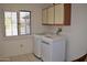 Laundry room with washer, dryer, and upper cabinets at 20619 N Echo Mesa Dr, Sun City West, AZ 85375