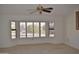 Spacious living room with bay window and a ceiling fan at 20619 N Echo Mesa Dr, Sun City West, AZ 85375