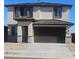 Two-story house with brown garage door and light-colored exterior at 20815 N 223Rd Ave, Surprise, AZ 85387