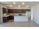 Modern kitchen with dark brown cabinets and a large island at 20815 N 223Rd Ave, Surprise, AZ 85387