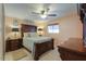 Spacious bedroom with large wood bed frame and ceiling fan at 221 E Nebraska St, Florence, AZ 85132