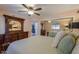 Bright bedroom with mirrored closet doors and ceiling fan at 221 E Nebraska St, Florence, AZ 85132