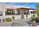 Relaxing front patio with umbrella, small table, and desert landscaping at 221 E Nebraska St, Florence, AZ 85132