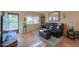 Bright living room with dark leather sofa and tile floors at 221 E Nebraska St, Florence, AZ 85132