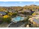 Aerial view of community pool and spa, surrounded by residential buildings at 2425 W Bronco Butte Trl # 2037, Phoenix, AZ 85085