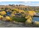 Aerial view of a community dog park with shaded areas and agility equipment at 2425 W Bronco Butte Trl # 2037, Phoenix, AZ 85085