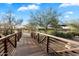 Wooden footbridge with metal railings leading to community amenities at 2425 W Bronco Butte Trl # 2037, Phoenix, AZ 85085