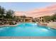 Resort-style pool with a covered seating area and lush landscaping at 2425 W Bronco Butte Trl # 2037, Phoenix, AZ 85085