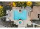 Directly above view of community pool and spa with surrounding lounge chairs and umbrellas at 2425 W Bronco Butte Trl # 2037, Phoenix, AZ 85085