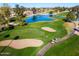 Community aerial view, showcasing a golf course and lake at 25046 S Foxglenn Dr, Sun Lakes, AZ 85248