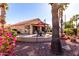 Landscaped backyard with patio, seating area, and desert plants at 25046 S Foxglenn Dr, Sun Lakes, AZ 85248