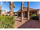 Spacious backyard with gravel landscaping and mature palm trees at 25046 S Foxglenn Dr, Sun Lakes, AZ 85248