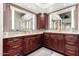 Double vanity bathroom with granite countertops and large mirror at 25046 S Foxglenn Dr, Sun Lakes, AZ 85248