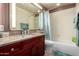 Clean bathroom with granite vanity, tub shower combo, and updated fixtures at 25046 S Foxglenn Dr, Sun Lakes, AZ 85248