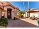 Inviting front courtyard with brick pavers and lush landscaping at 25046 S Foxglenn Dr, Sun Lakes, AZ 85248