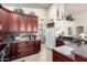 Kitchen with dark wood cabinets, granite countertops, and stainless steel appliances at 25046 S Foxglenn Dr, Sun Lakes, AZ 85248