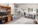 Living room with two sofas, built-in shelving and view of kitchen at 25046 S Foxglenn Dr, Sun Lakes, AZ 85248