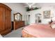 Main bedroom with a king bed, large dresser and walk-in closet at 25046 S Foxglenn Dr, Sun Lakes, AZ 85248