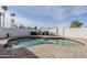 Kidney shaped pool with brick patio and surrounding lawn at 2818 S Cottonwood Dr, Tempe, AZ 85282