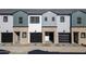 Three-unit townhome complex with modern brick exteriors and attached garages at 2820 W Eagle Talon Rd, Phoenix, AZ 85085