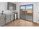 Modern kitchen with gray cabinets and sliding glass door at 2820 W Eagle Talon Rd, Phoenix, AZ 85085