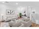 Spacious living room with light colored sofas and wood floors at 2820 W Eagle Talon Rd, Phoenix, AZ 85085