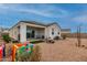 Backyard patio, gravel yard, and play area at 3224 N Lainey Ln, Buckeye, AZ 85396