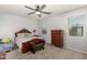 Spacious bedroom with a wooden bed frame and dresser at 3224 N Lainey Ln, Buckeye, AZ 85396