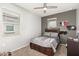 Well-lit bedroom with a ceiling fan and a built-in dresser at 3224 N Lainey Ln, Buckeye, AZ 85396