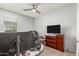 Bright bedroom with two monitors, a dresser, and a ceiling fan at 3224 N Lainey Ln, Buckeye, AZ 85396