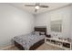 Bedroom with a window, ceiling fan, and a nightstand at 3224 N Lainey Ln, Buckeye, AZ 85396