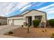 Two-car garage, stone accents, and nicely landscaped front yard at 3224 N Lainey Ln, Buckeye, AZ 85396