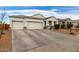 Two-car garage, driveway, and nicely landscaped front yard at 3224 N Lainey Ln, Buckeye, AZ 85396