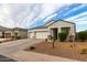 White stucco home with a two-car garage and desert landscaping at 3224 N Lainey Ln, Buckeye, AZ 85396