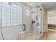 Modern bathroom with a large glass shower, marble tile, and a built-in bench at 34476 N 68Th Way, Scottsdale, AZ 85266